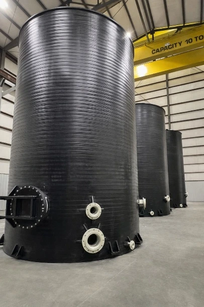 Black cylindrical tanks in the warehouse